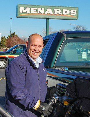 Menards store manager Kyle Krause fuels one of the company's new propane pickup trucks.