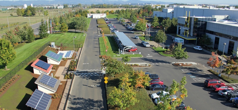 Photo of SolarWorld facilities, with parking lot, solar panels, and EVSE